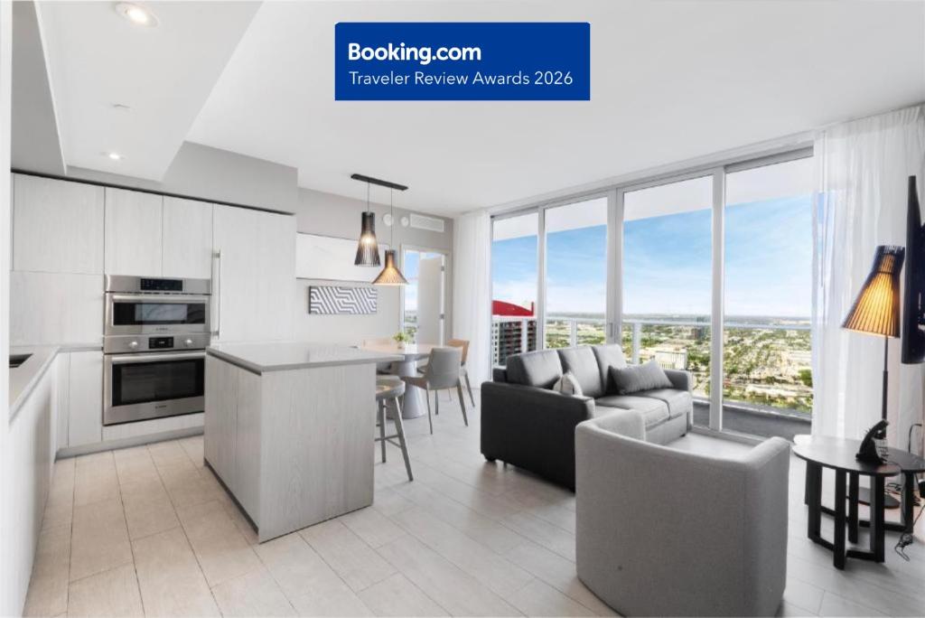 a kitchen and living room with a couch and a table at Stylish 3BR Resort Condo with Beach Access, Two Infinity Pools and Private Balcony -NO RESORT & NO PARKING FEES, CHECK DETAILS in Hollywood