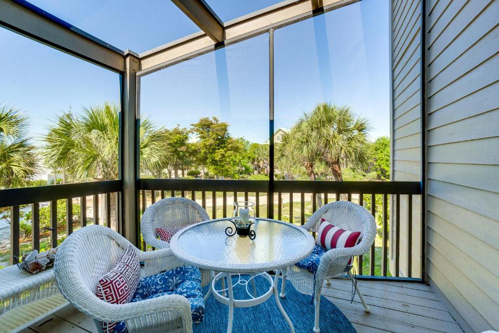 a patio with a table and chairs on a balcony at Pool Access! Private Island Condo in Placida in Placida