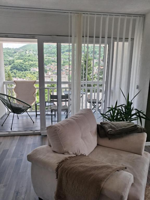 a living room with a couch and a balcony at Vila jajcegrad in Jajce