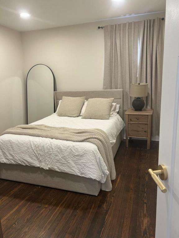 a bedroom with a large bed and a wooden floor at The Signature Stay in Clifton