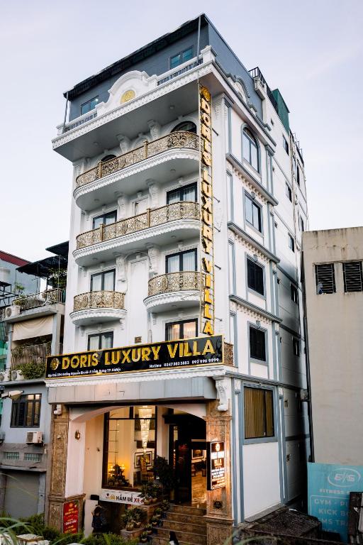 a building with a sign that reads doors luxury villa at Doris Luxury Hotel in Hanoi