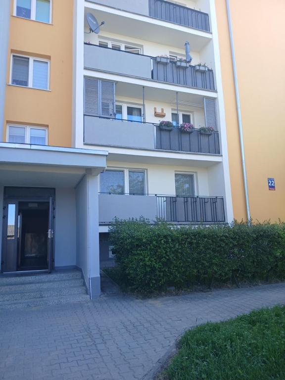 an apartment building with balconies and plants on it at Mieszkanie Piaskowa 22 in Kraśnik