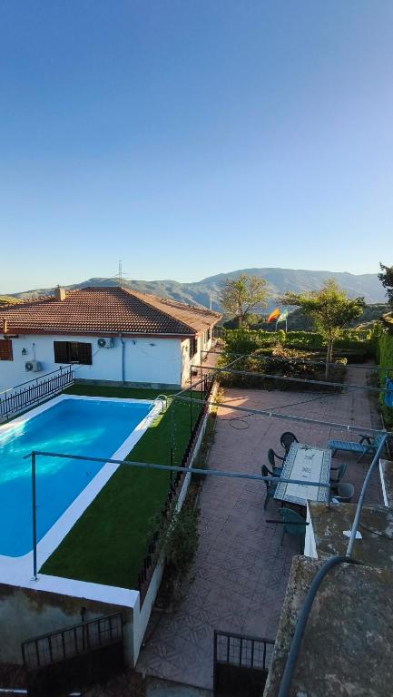 a view of a swimming pool in a yard at Chalet Venta del Aire Cortijo Terrón in Lanjarón