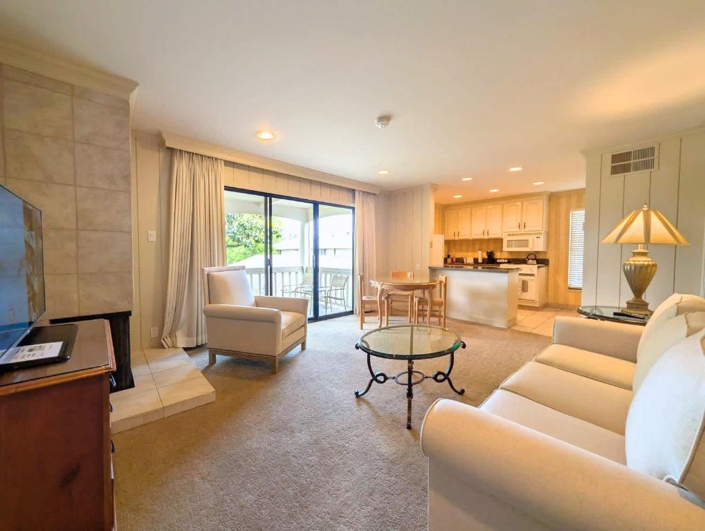 a living room with a couch and a table and a kitchen at Silverado Resort and Spa 221 in Napa