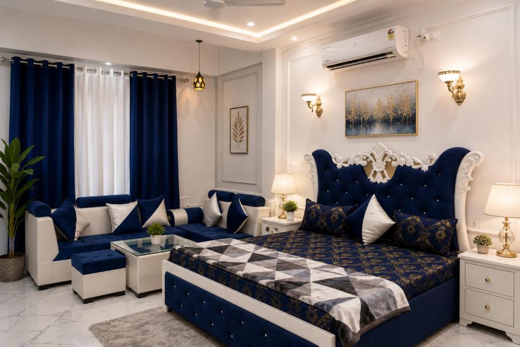 a bedroom with a blue bed and a couch at Green Valley Resort in Dūngarpur