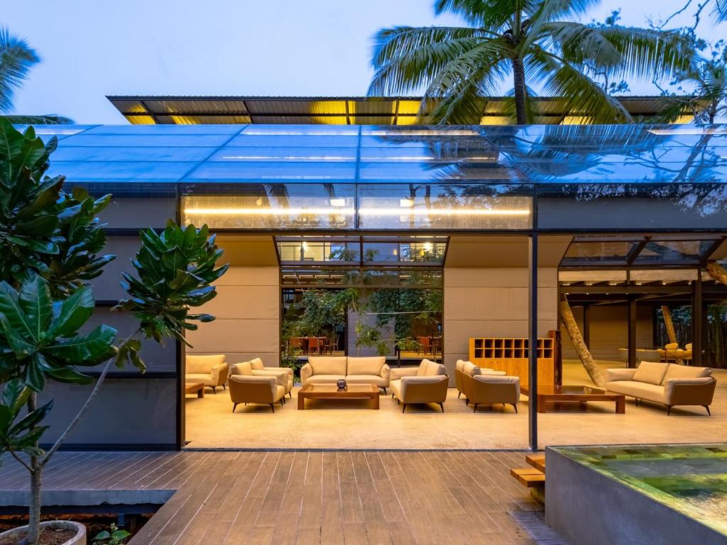 a lobby of a building with couches and chairs at BlackRoots Unawatuna in Unawatuna
