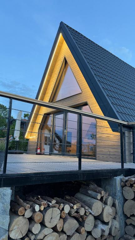 a house with a black roof and glass windows at Azad A-Frame in Şotrile