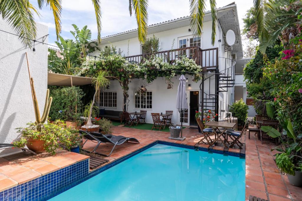 a swimming pool in front of a house at Villa Costa Rose in Cape Town