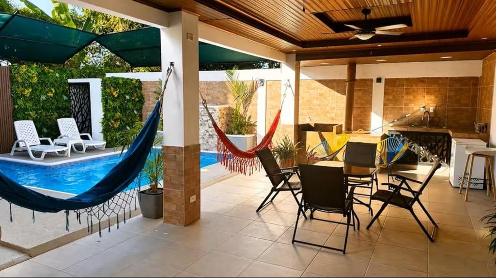 a patio with a hammock and a table and chairs at Chitre Villa by Otium in Monagrillo