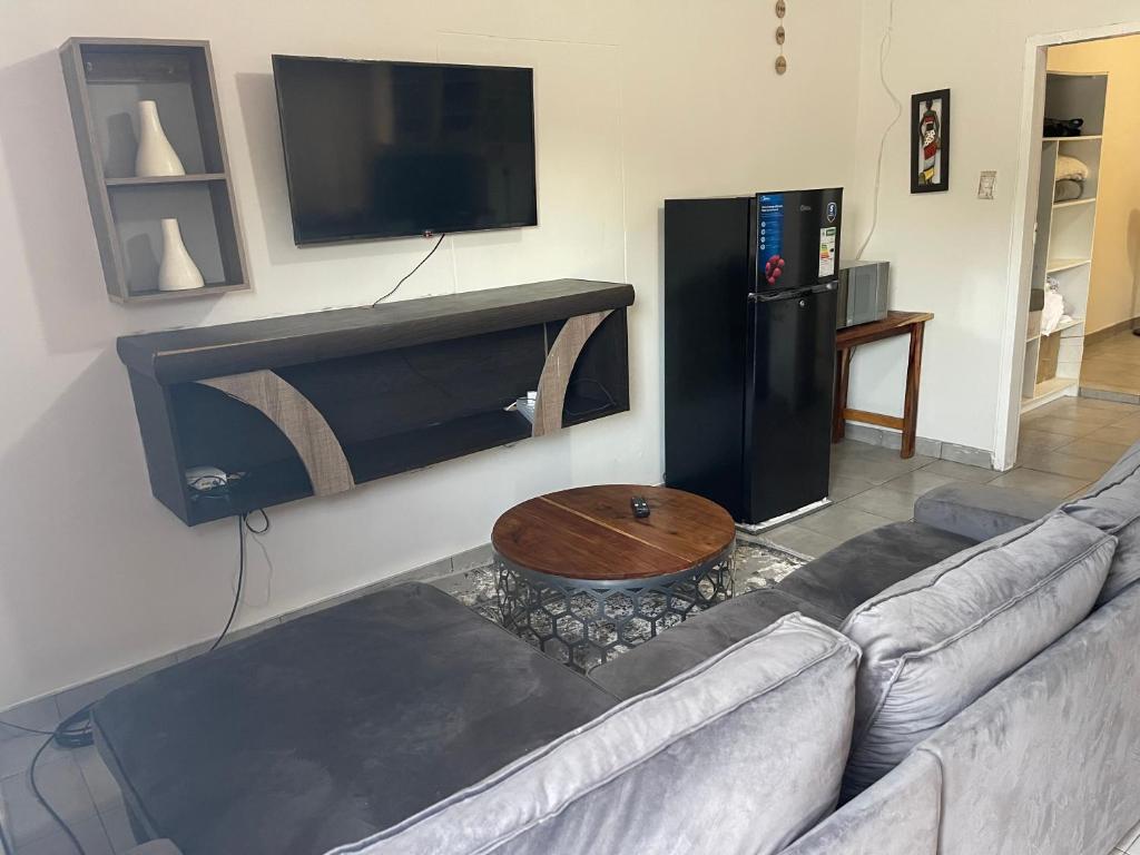 a living room with a couch and a tv at Kokoma Apartment in Katima Mulilo in Katima Mulilo