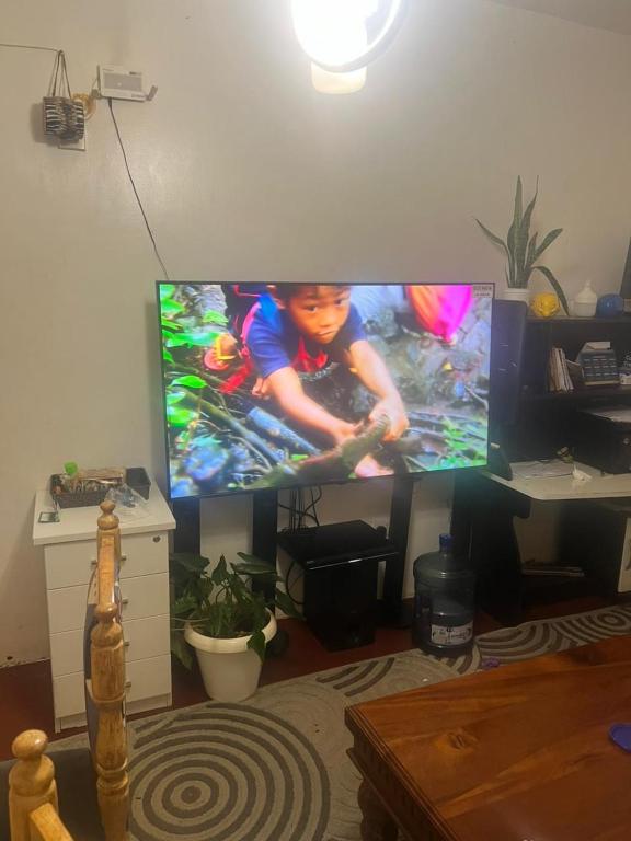 a living room with a flat screen tv on the wall at Chepchephm in Makindi