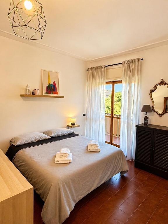 a bedroom with a bed with two towels on it at Rome Home Cinecittà in Rome