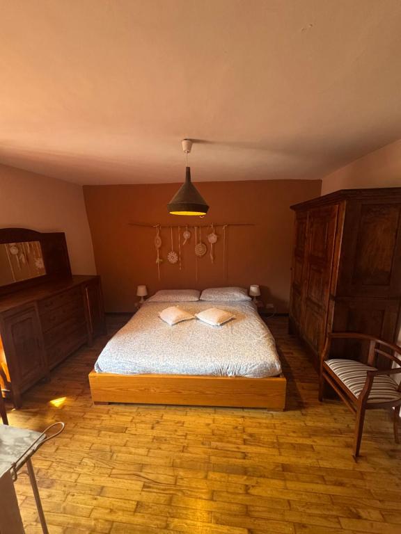 a bedroom with a bed with two pillows on it at La Canàoula in Bobbio Pellice