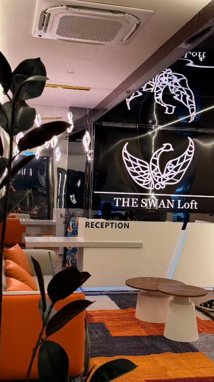 a room with a sign that reads the swan lot reception at THE SWAN loft in Sibu