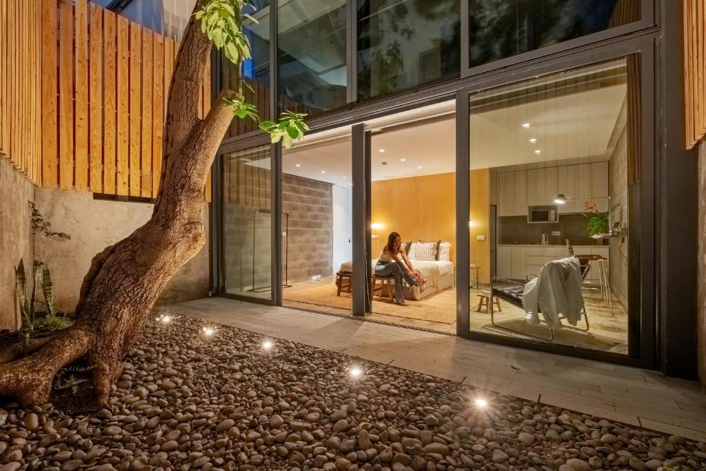 a house with a tree in the middle of a room at The 21 by Homie in Ribeira Brava