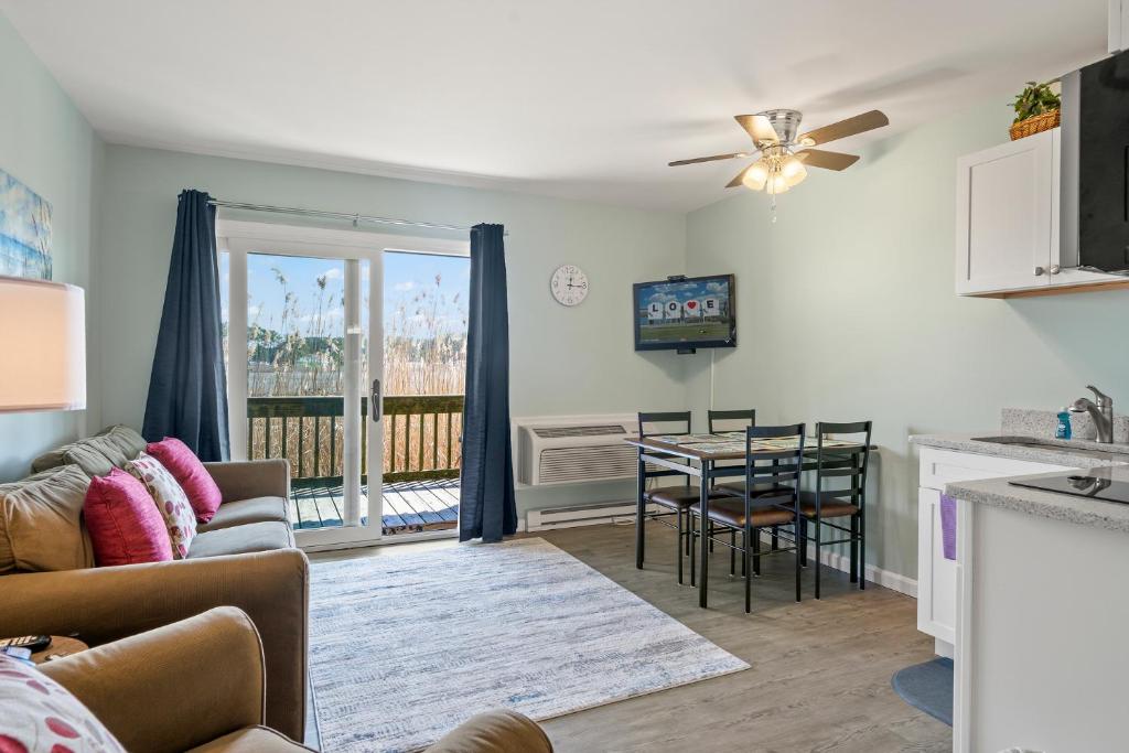 a living room with a couch and a table at Assateague Inn 105-S in Deep Hole