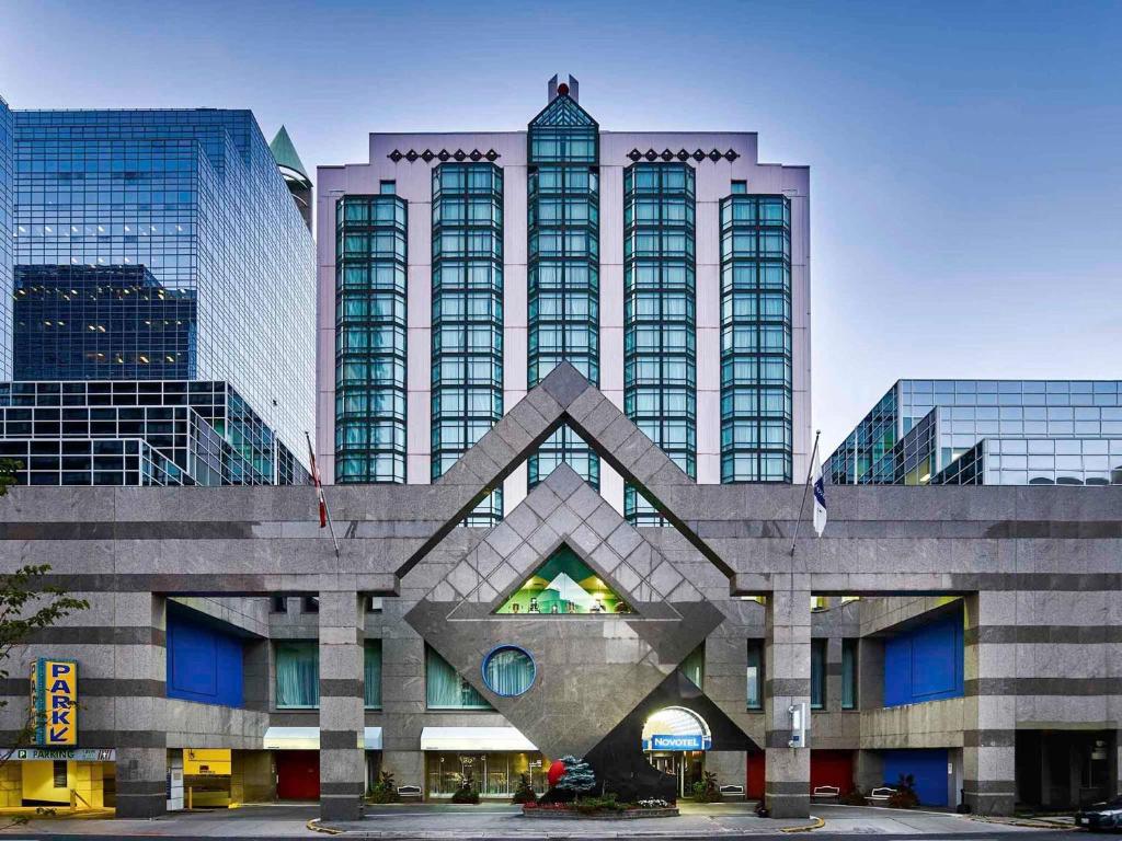 a large building with tall buildings in the background at Novotel Toronto North York in Toronto