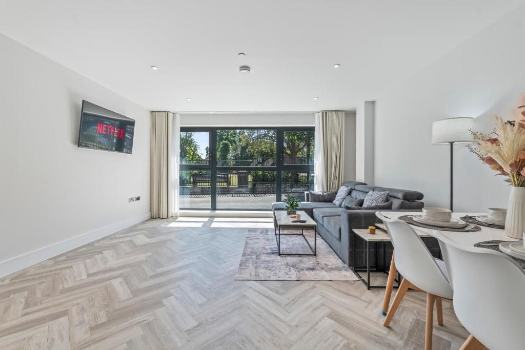 a living room with a couch and a table at Spacious North London Flat Sleeps 4 in New Barnet
