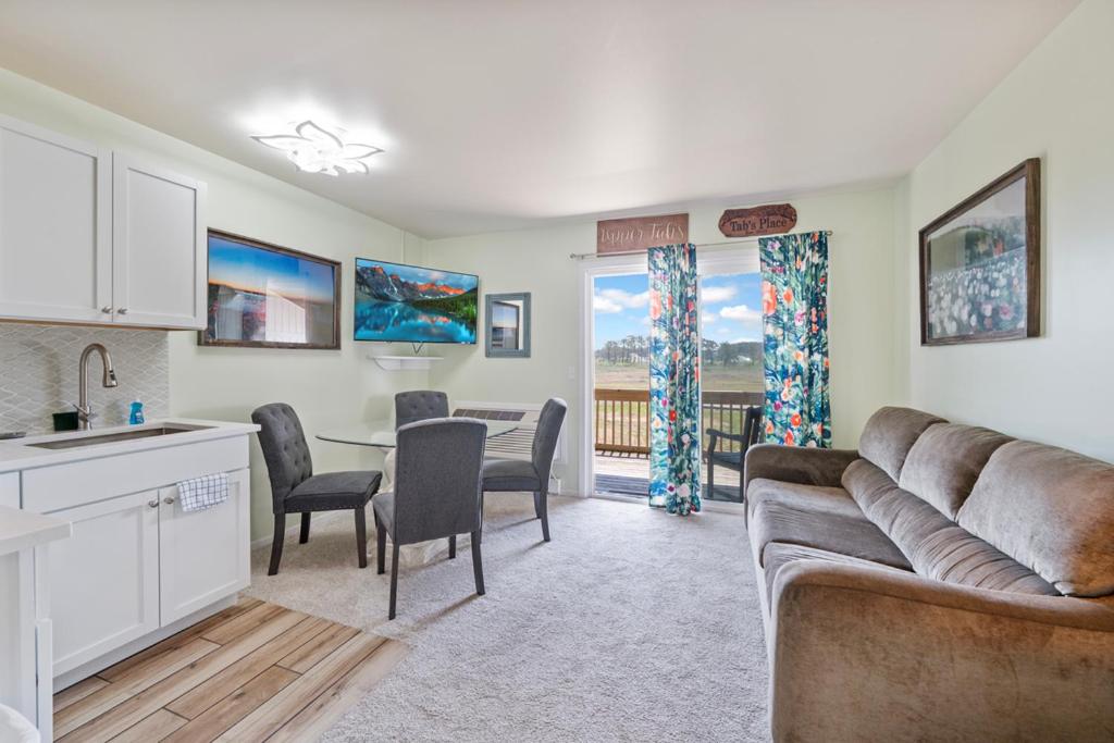 a kitchen and living room with a couch and a table at Assateague Inn 206-S in Chincoteague