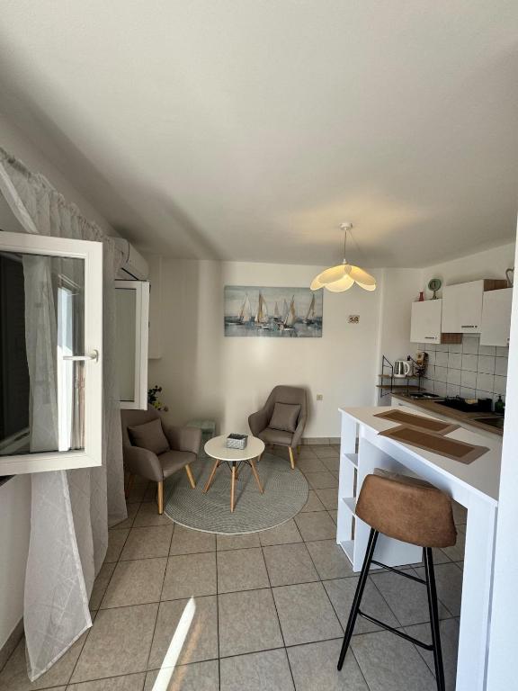 a kitchen and living room with a table and chairs at Apartment Niko in Pakoštane