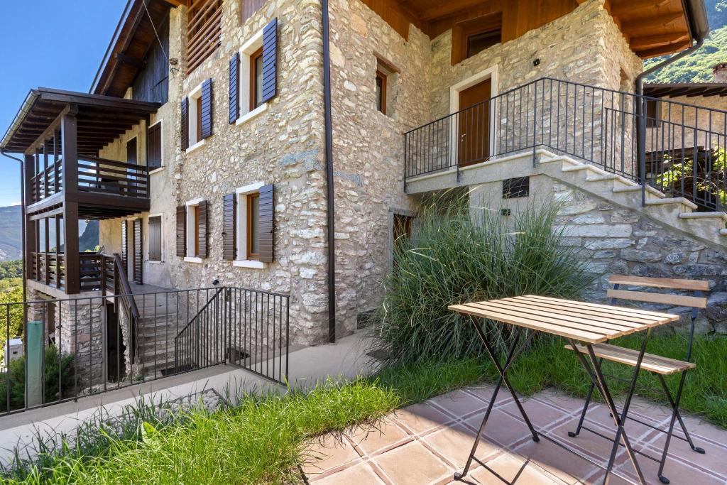 a wooden table sitting in front of a building at Casa Zucchelli in Tenno