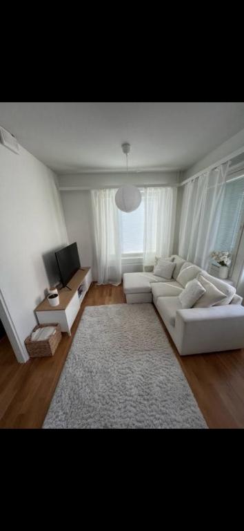 a living room with a white couch and a table at Lapland home in Rovaniemi