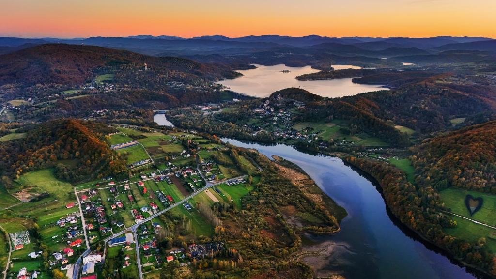 an aerial view of a resort on a river at DAGA-Domki Nad Soliną in Solina