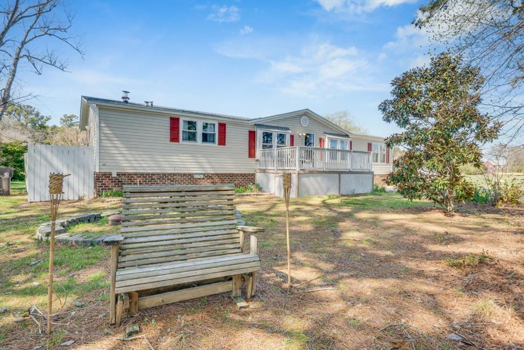 a house with a bench in front of it at Bayside Haven in Deep Hole