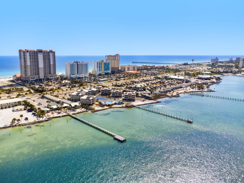 an aerial view of a beach with a pier and buildings at Soundside Holiday Beach Resort in Pensacola Beach