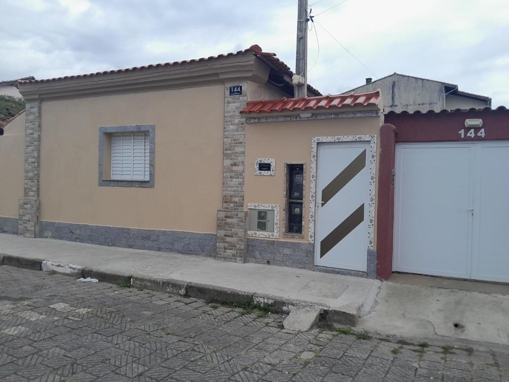 a building with a large white door in front of it at Esteira in Iguape