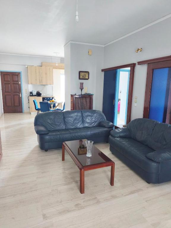 a living room with two couches and a coffee table at Nicolas Luxury Apartment in Amalias