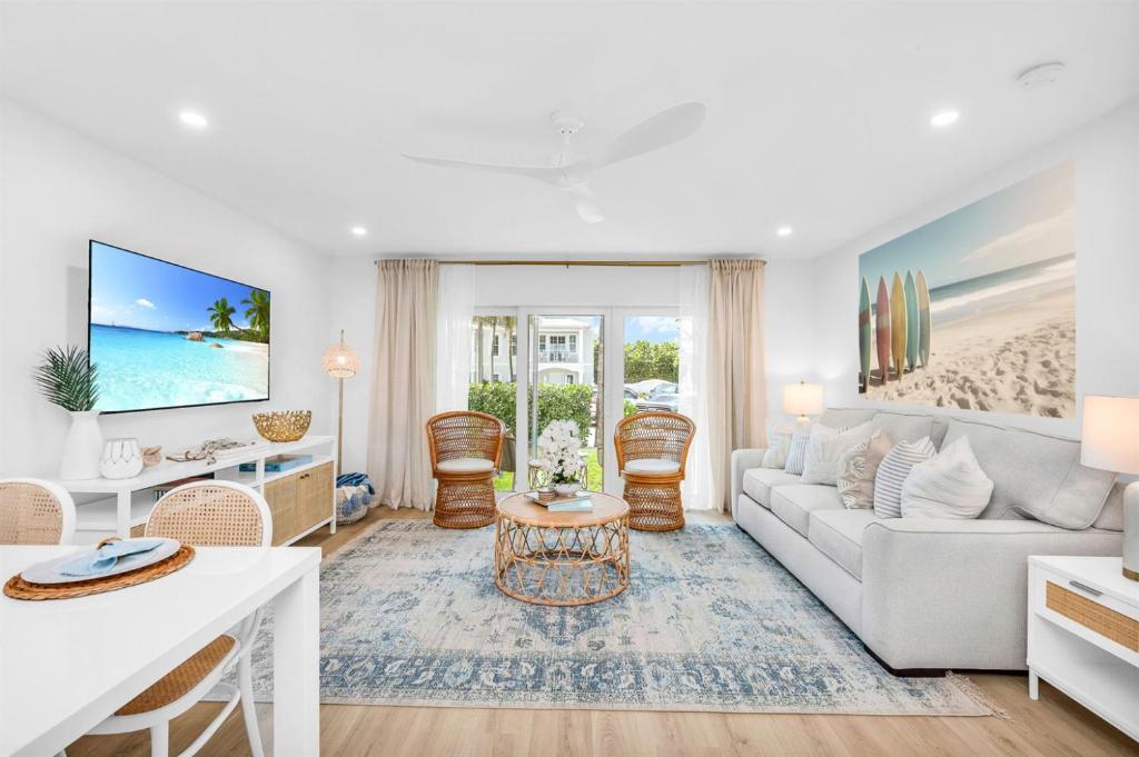 a living room with a couch and a table at The Beach Villa in Juno! 1-Steps to the Beach in Juno Beach