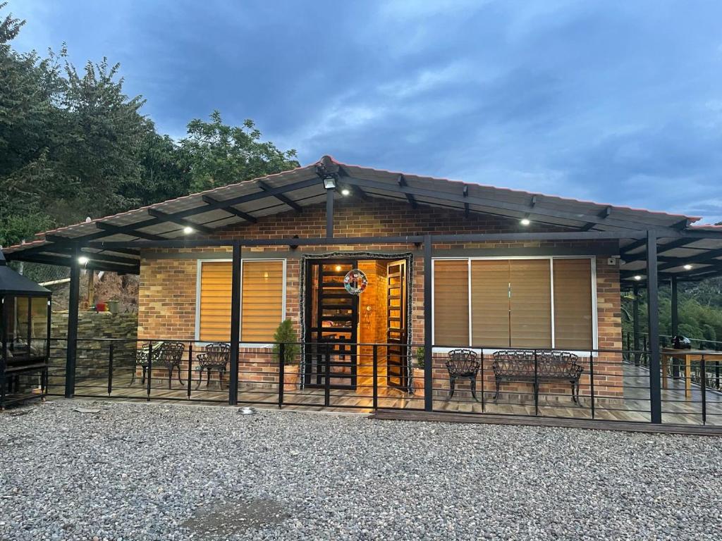 a house with a patio with chairs and tables at la samara in Anapoima