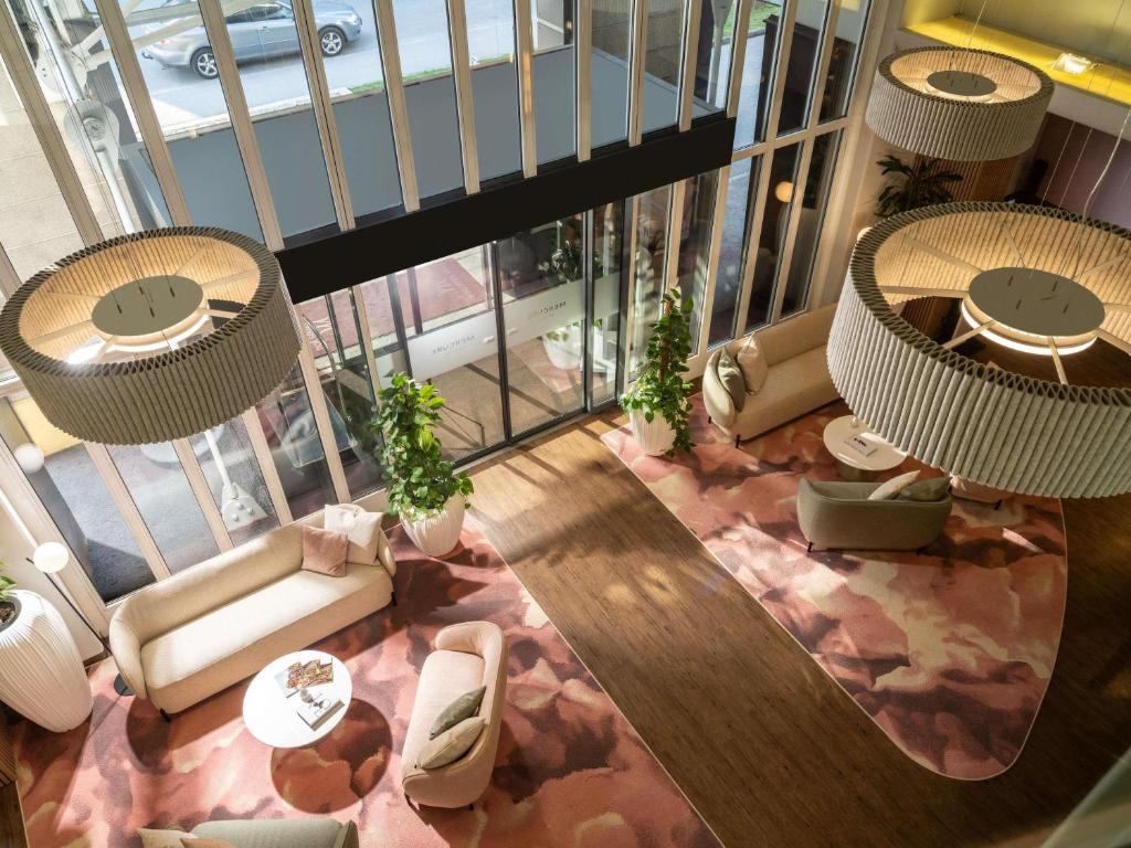 an overhead view of a living room with tables and chairs at Mercure Salzburg City in Salzburg