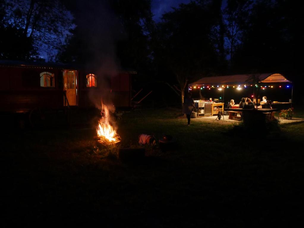 a camp fire in the yard at night at La Roulotte du Fier in Annecy