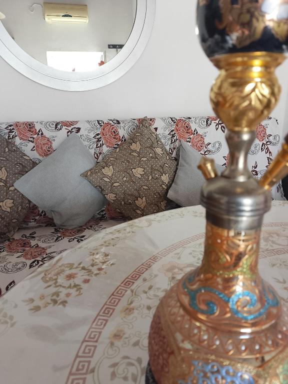 a lamp sitting on a bed in front of a mirror at sevas'view in Émbonas