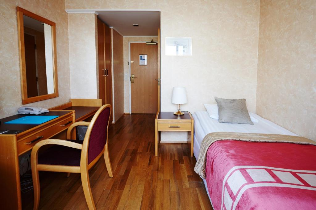Rúm í herbergi á Fosshotel Rauðará