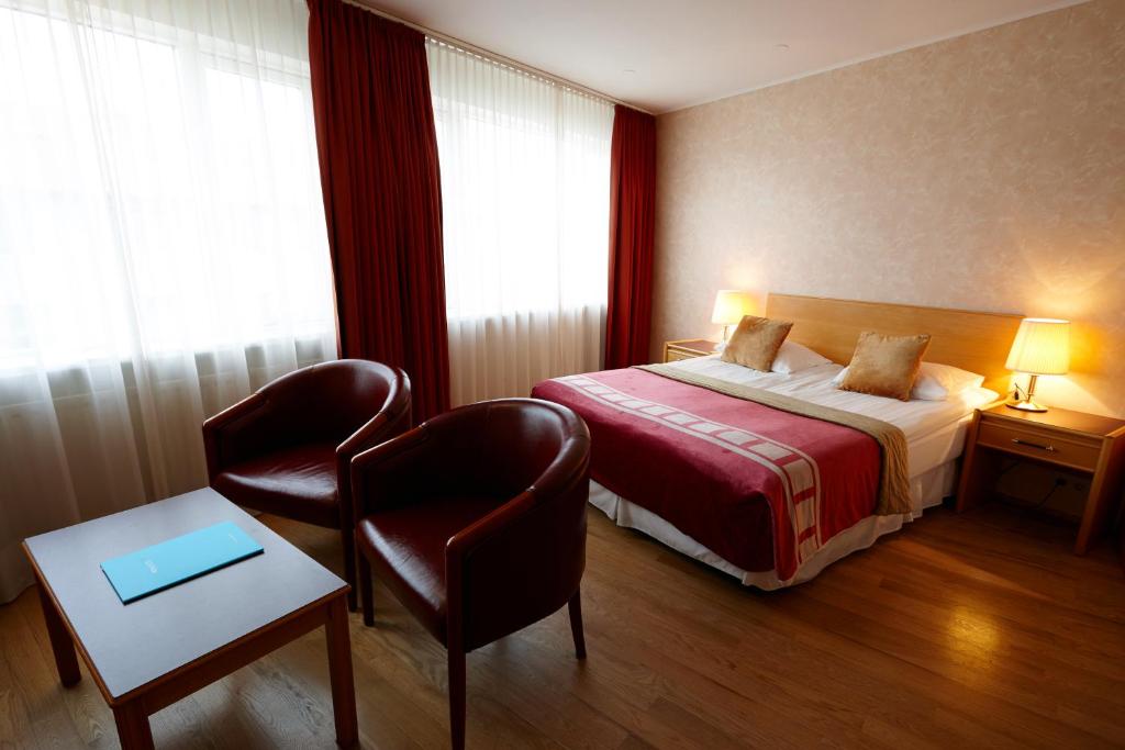 Rúm í herbergi á Fosshotel Rauðará