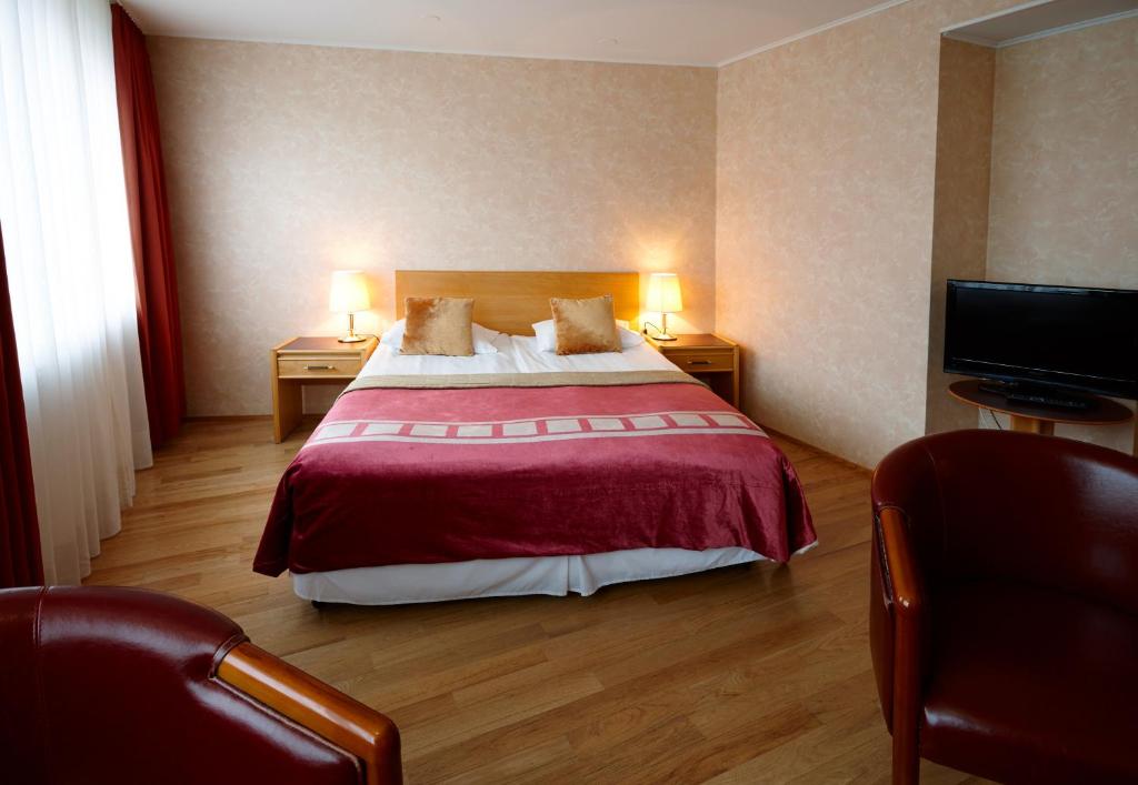 Rúm í herbergi á Fosshotel Rauðará