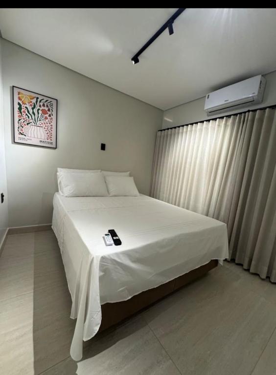 a bedroom with a large white bed in a room at You Smart Flats - Hotel in Formosa