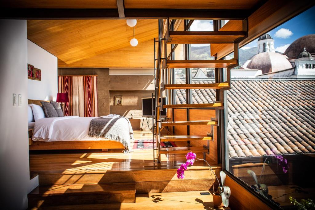 a bedroom with a ladder leading to a bed at Casa Santa Clara - Colonial Boutique Hotel in Quito