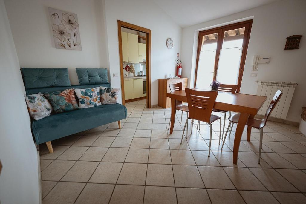a living room with a couch and a table and chairs at Orli Home e Relax in Casole dʼElsa