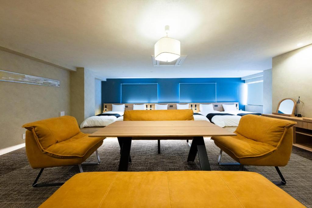 a dining room with a table and two chairs at ホテル雅々音 in Sasebo