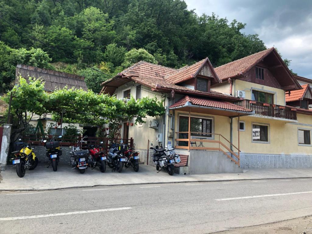 a group of motorcycles parked in front of a house at Casa Dina in Băile Herculane