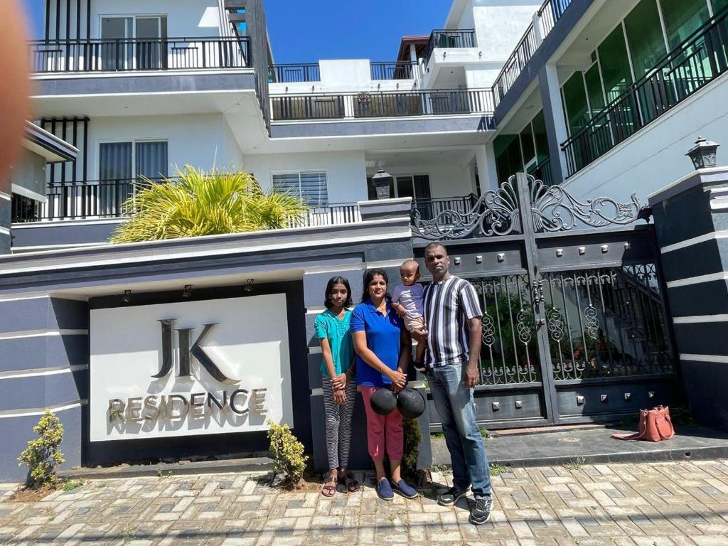 a group of people standing in front of a building at JK Residence Trincomalee in Trincomalee