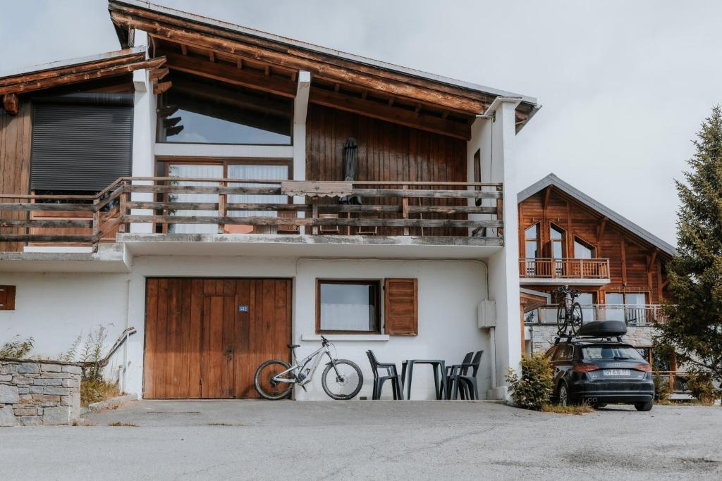 a house with a bike parked in front of it at Jean Pierre Skilodge in La Toussuire