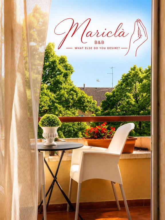 a balcony with a table and white chairs and a window at Mariclà Boutique Rooms with Balcony & Free Parking in Verona