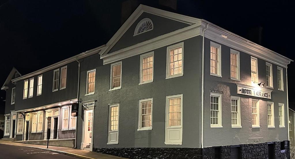 a black building with white doors and windows at night at Hotel Laurance in Luray