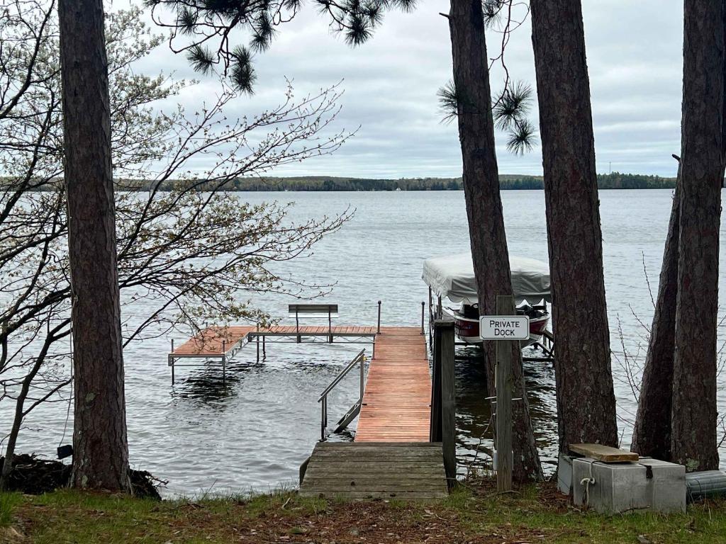 a dock on a lake with a sign on it at American Eagle Retreat in Conover