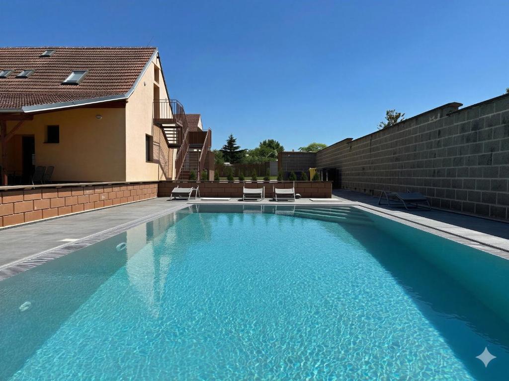 a swimming pool with blue water in a house at Penzion Trödler in Brod nad Dyjí